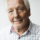 Portrait of smiling senior man against white background