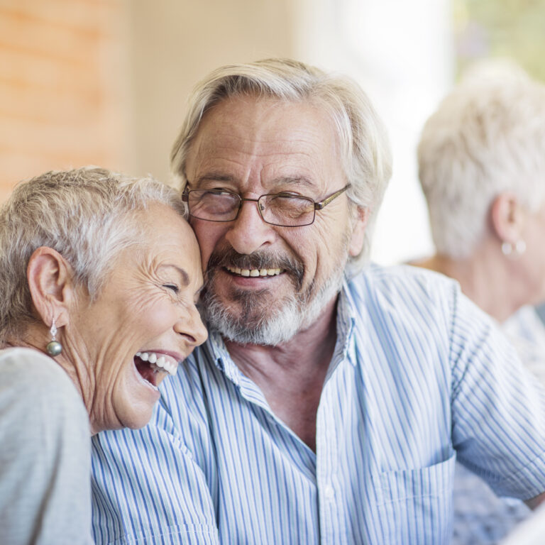 Cape Town, South Africa, happy elderly couples sitting on patio
