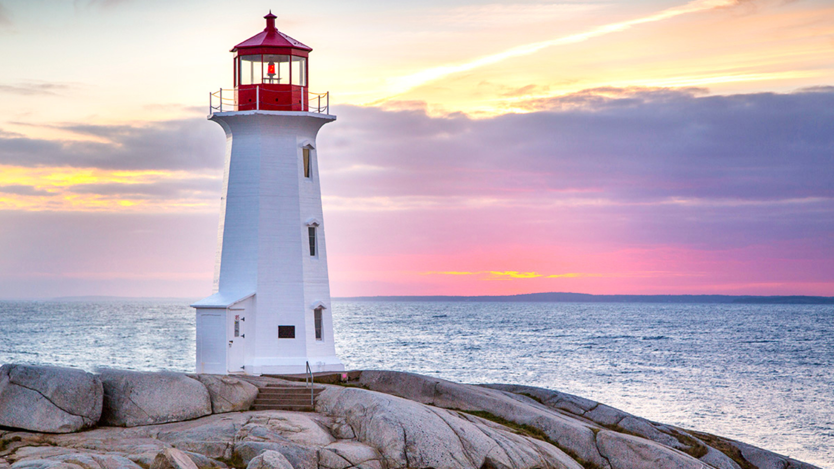 Sunset behind the lighthouse at Peggy's Cove near Halifax, Nova